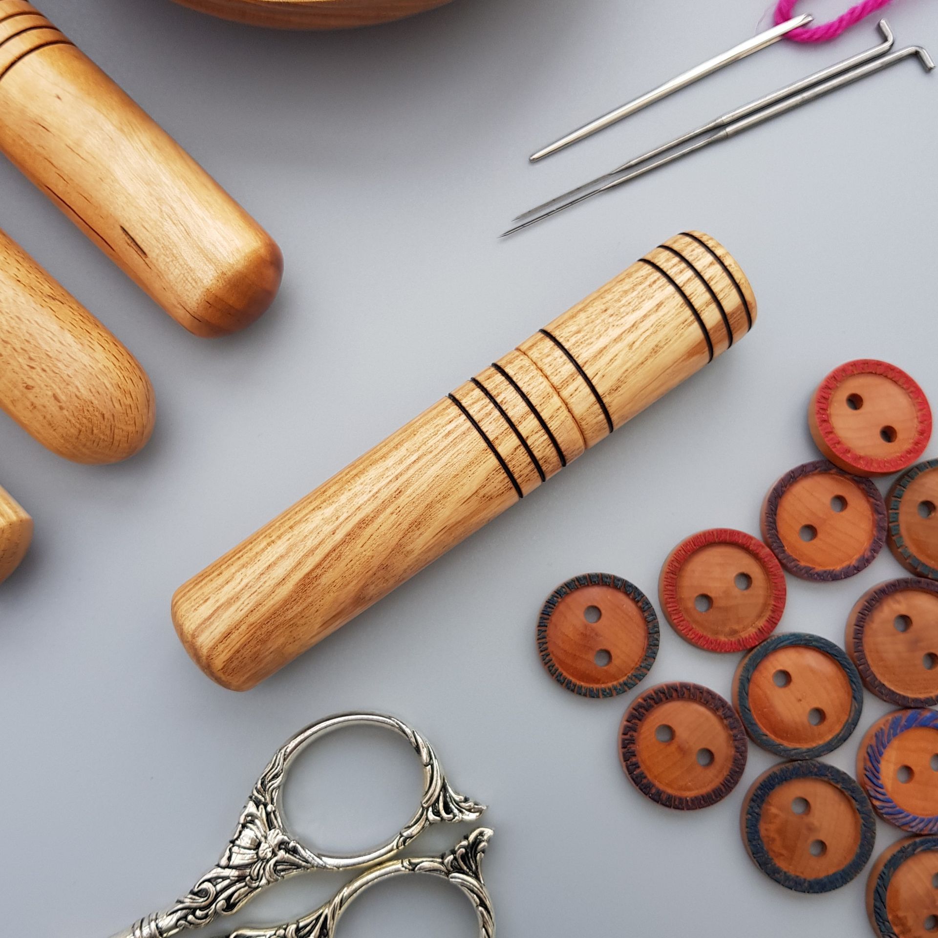 Wooden needle case in Ash with several rings burnt into the wood