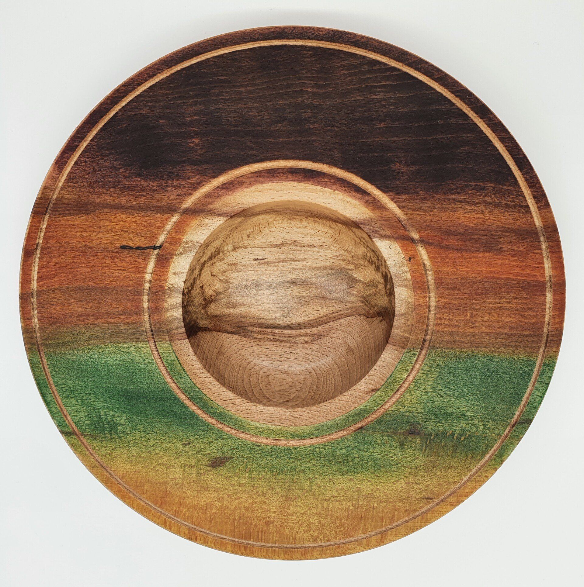 Large flamed beech bowl with a wide rim decorated with intrinsic staining, in the colours of Autumn, which allows the grain to still be seen