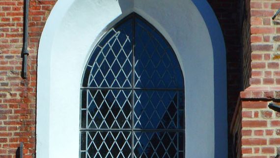 Das Bild zeigt das gotische Fenster über dem Haupteingang.
