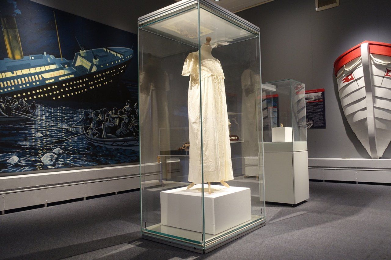 Exhibition display showcasing first class passenger Margaret Baron Welles Swift nightgown from Titanic.