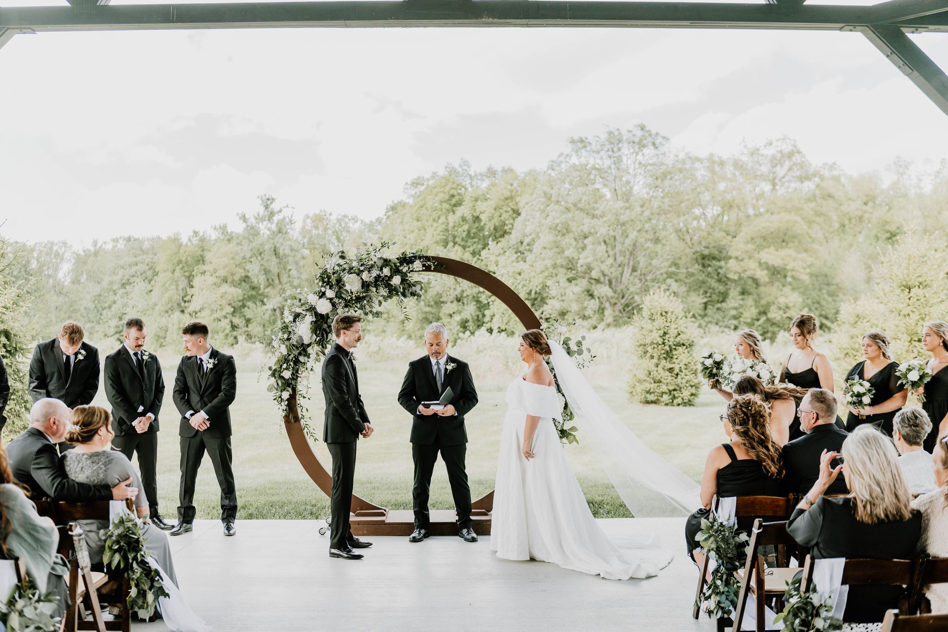 Romantic outdoor ceremony space at Fort Wayne wedding venue Union 12, on the covered back porch with string lights and scenic views.