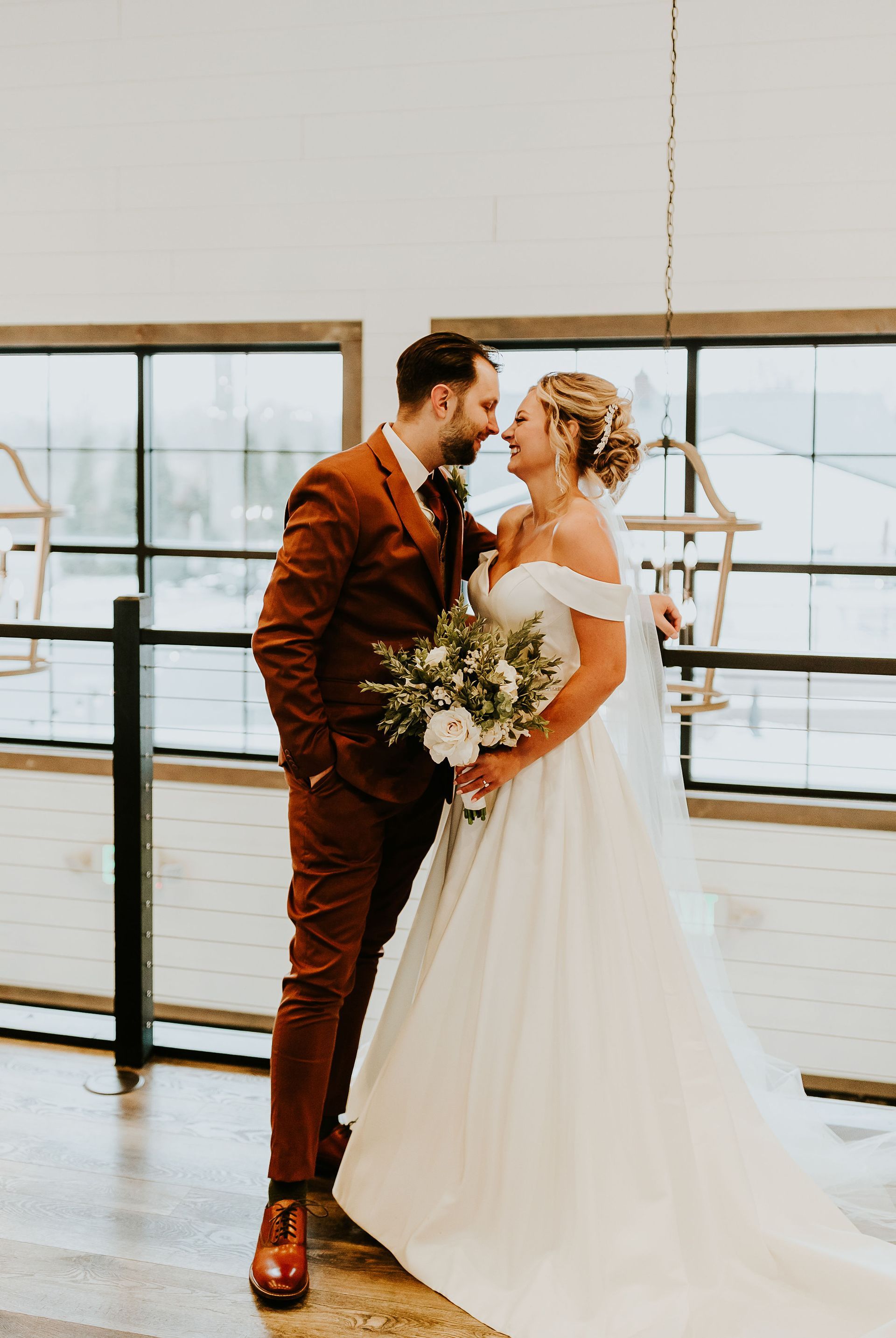 Newlyweds sharing a private moment on the balcony at Union 12, a modern wedding venue near Fort Wayne with beautiful indoor and outdoor spaces.