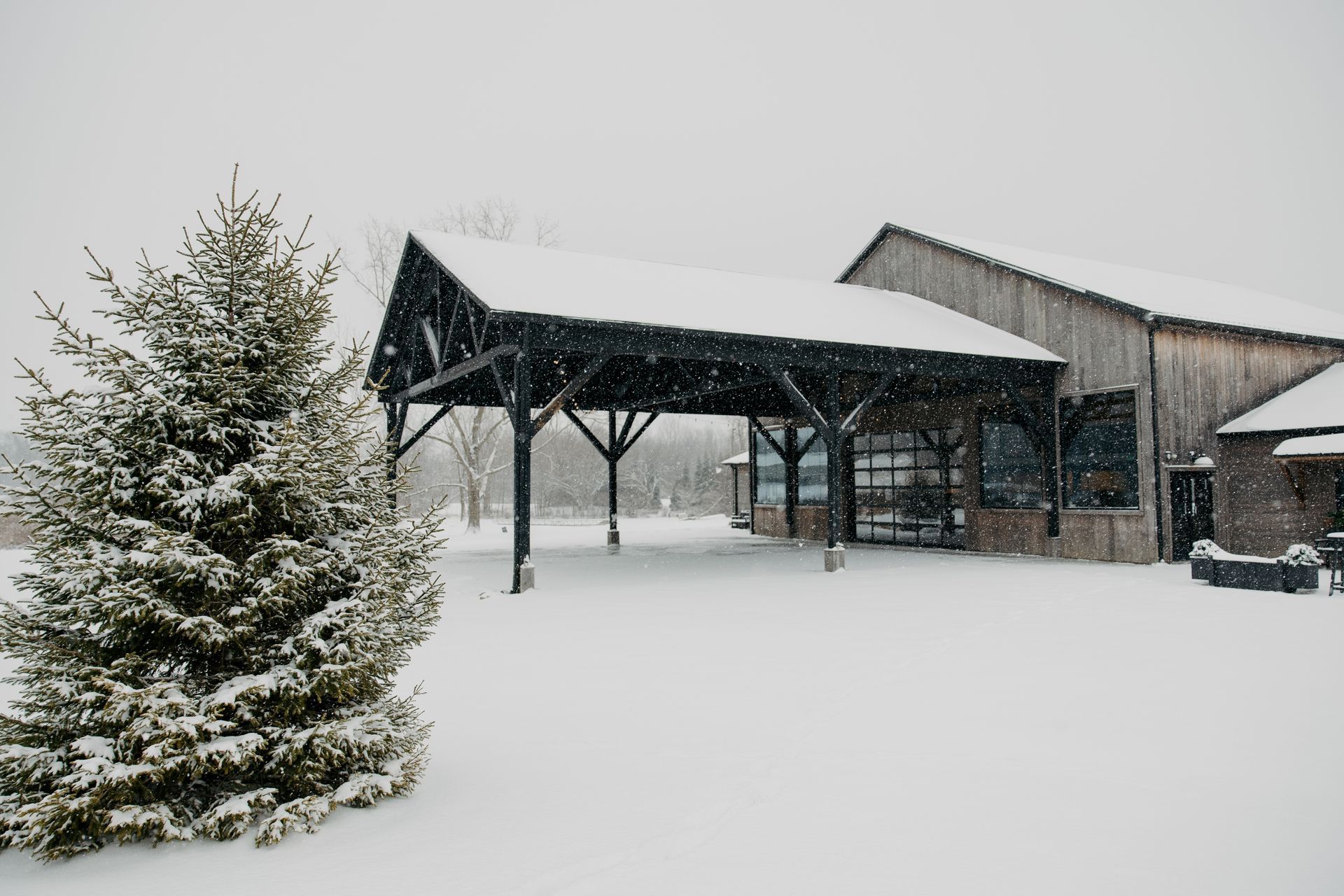 A picturesque view of Union 12's exterior, with snow gently falling. A Fort Wayne Indiana winter wedding ceremony and reception.