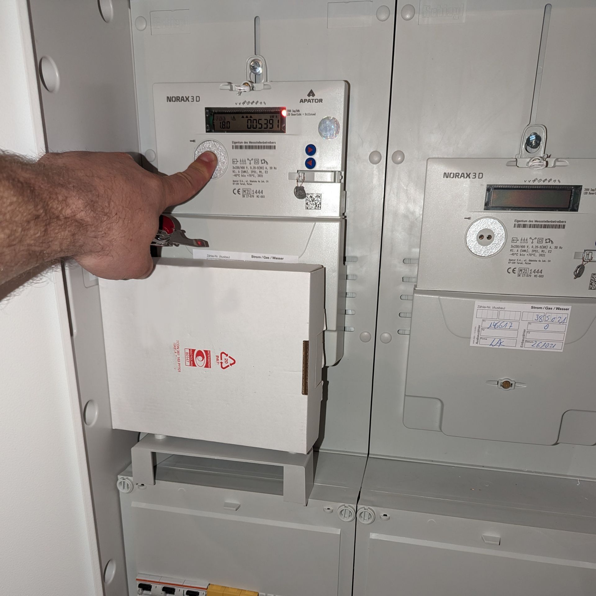 Optimale Energieverträge - perfekt auf Ihren Verbrauch abgestimmt. Eine Hand zeigt auf den Stromzähler, begleitet von Informationen über die Dienstleistungen der Enko Solutions GmbH zur Vermittlung von individuellen Strom- und Gasverträgen.