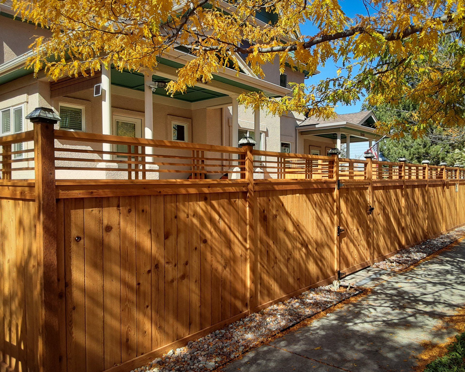 Lattice-top craftsman-style fence and gate.