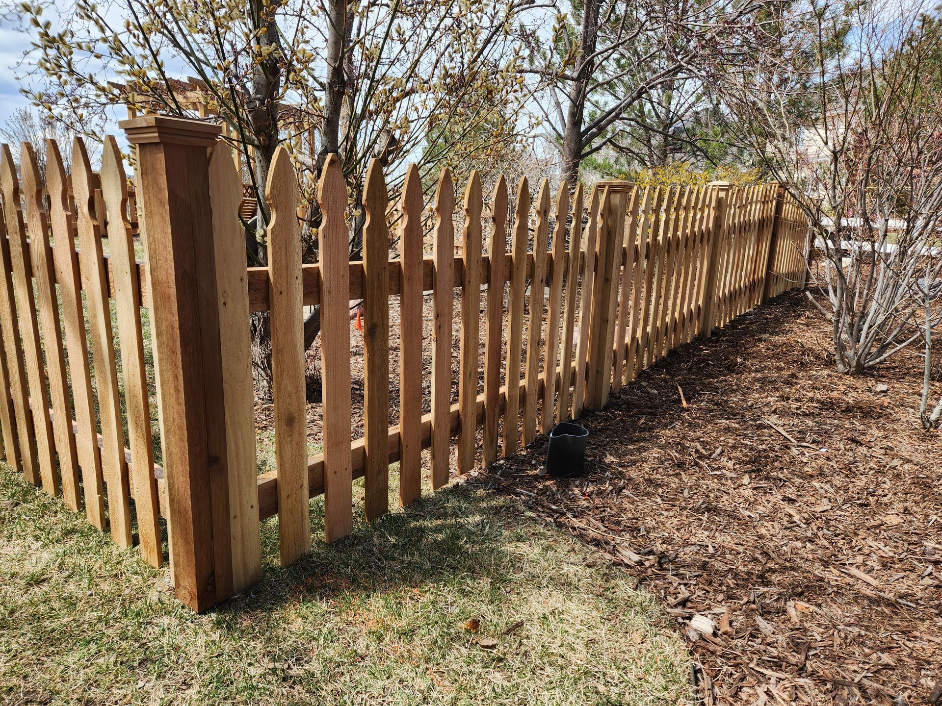 Gothic style picket cedar fence.