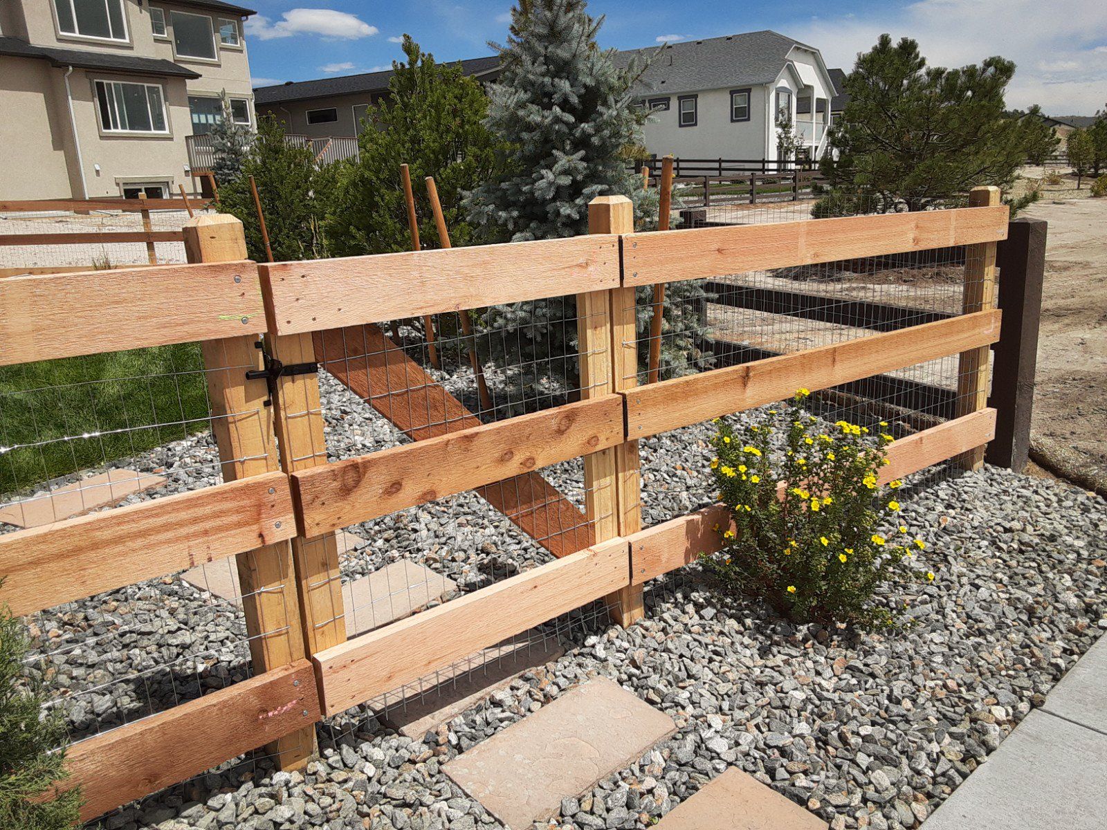 Three-rail 2x6 cedar fence and gate with dog wire.