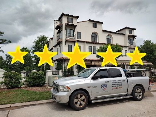 All Git Out Services truck siting in front of a home we are soft washing in Magnolia TX