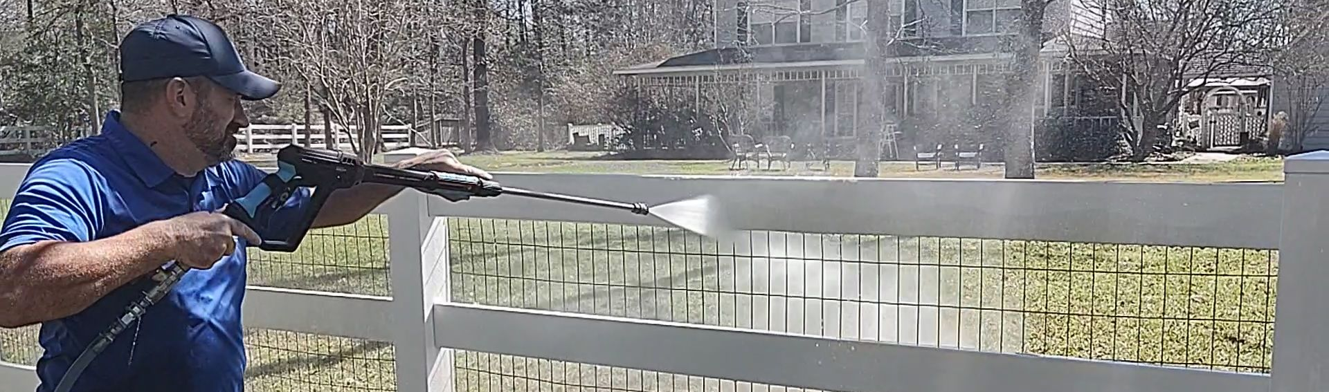 Pressure washing a vinyl fence in Magnolia Texas