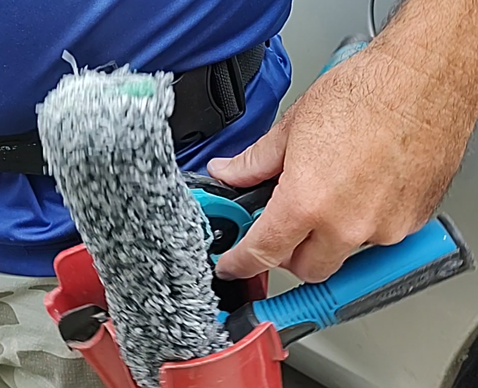 Window Cleaning with soap and water using a mop and squeegee