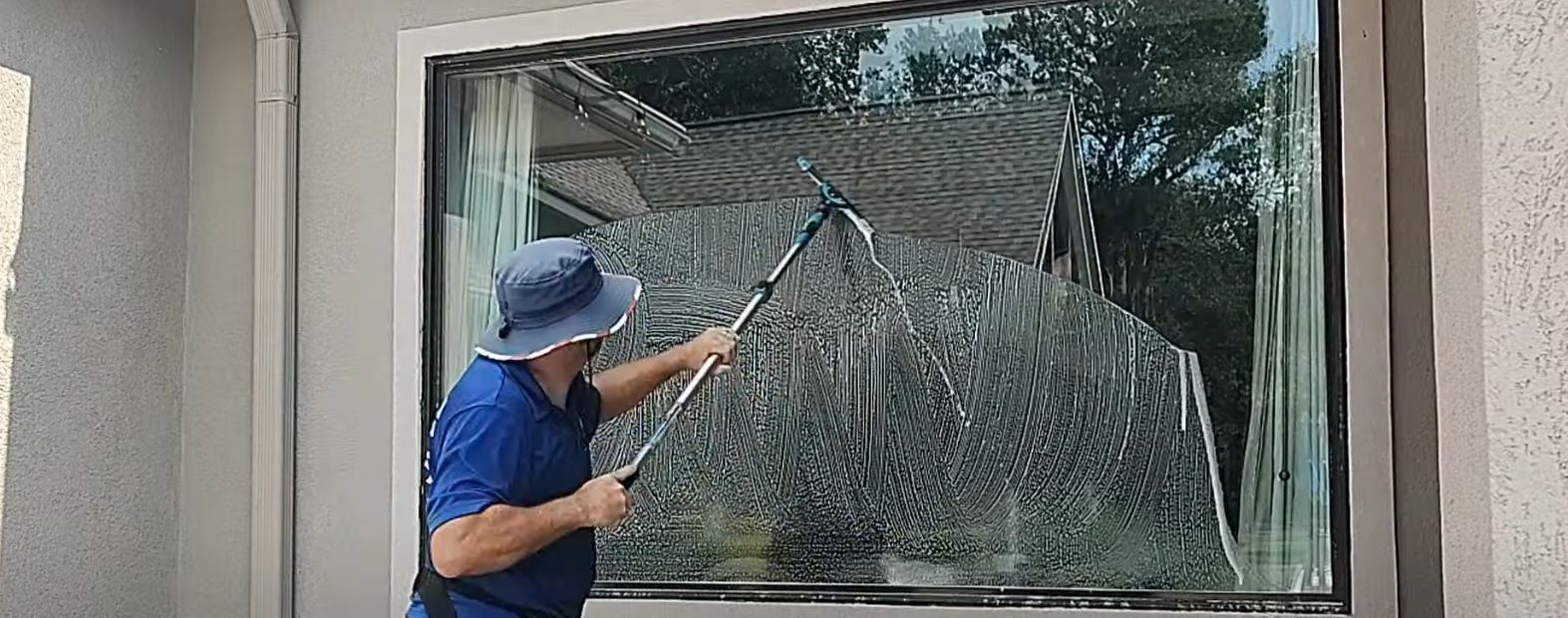 using a pole and special squeegee with a rotating and adjustable head to clean larger windows without getting on a ladder or step stool.