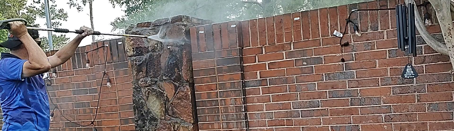 Pressure washing stone and brick walls in Magnolia Texas