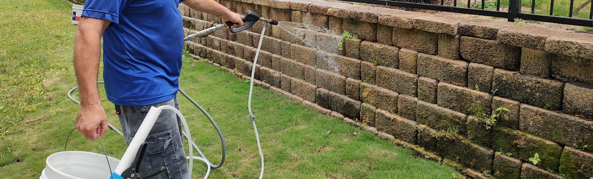 soft washing a retention wall to remove the algae and moss