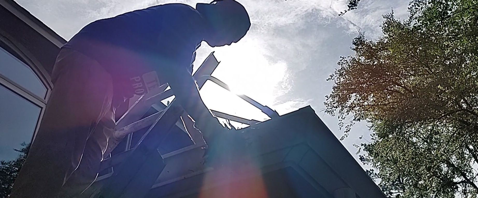 using a ladder to safely clean gutters in Montgomery Texas