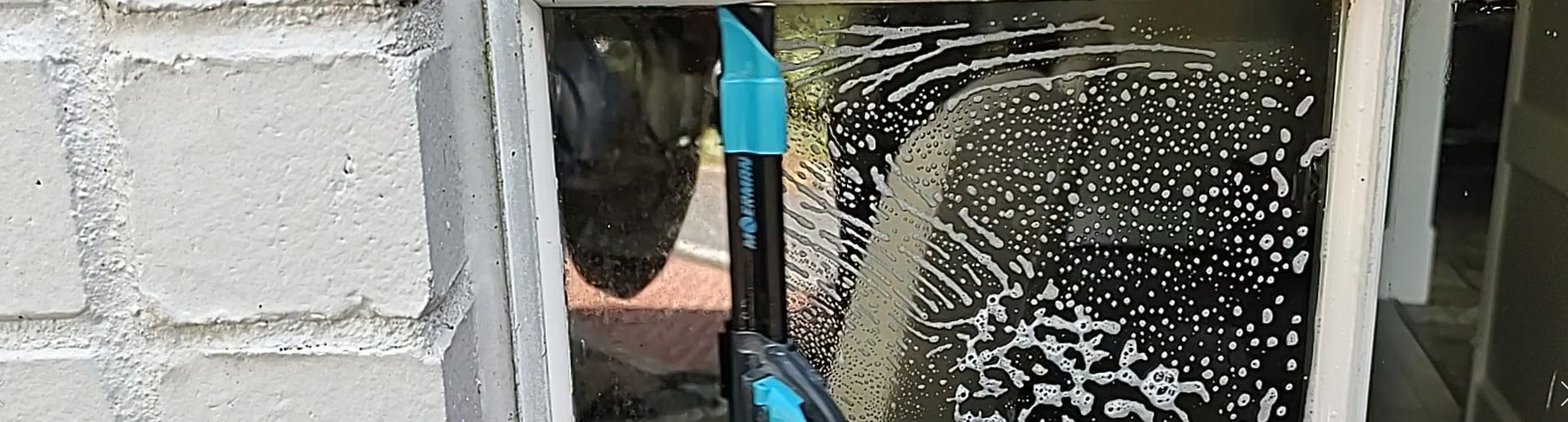 close up of squeegee on a French window pane in Magnolia TX