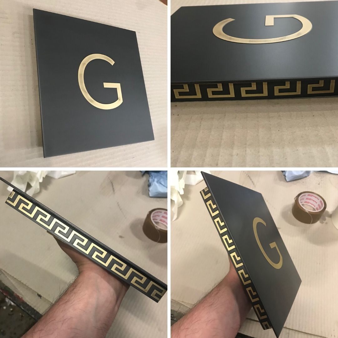 Brass patinated sign inlaid with chemical milled elements Brass patinated sign inlaid with chemical milled elements