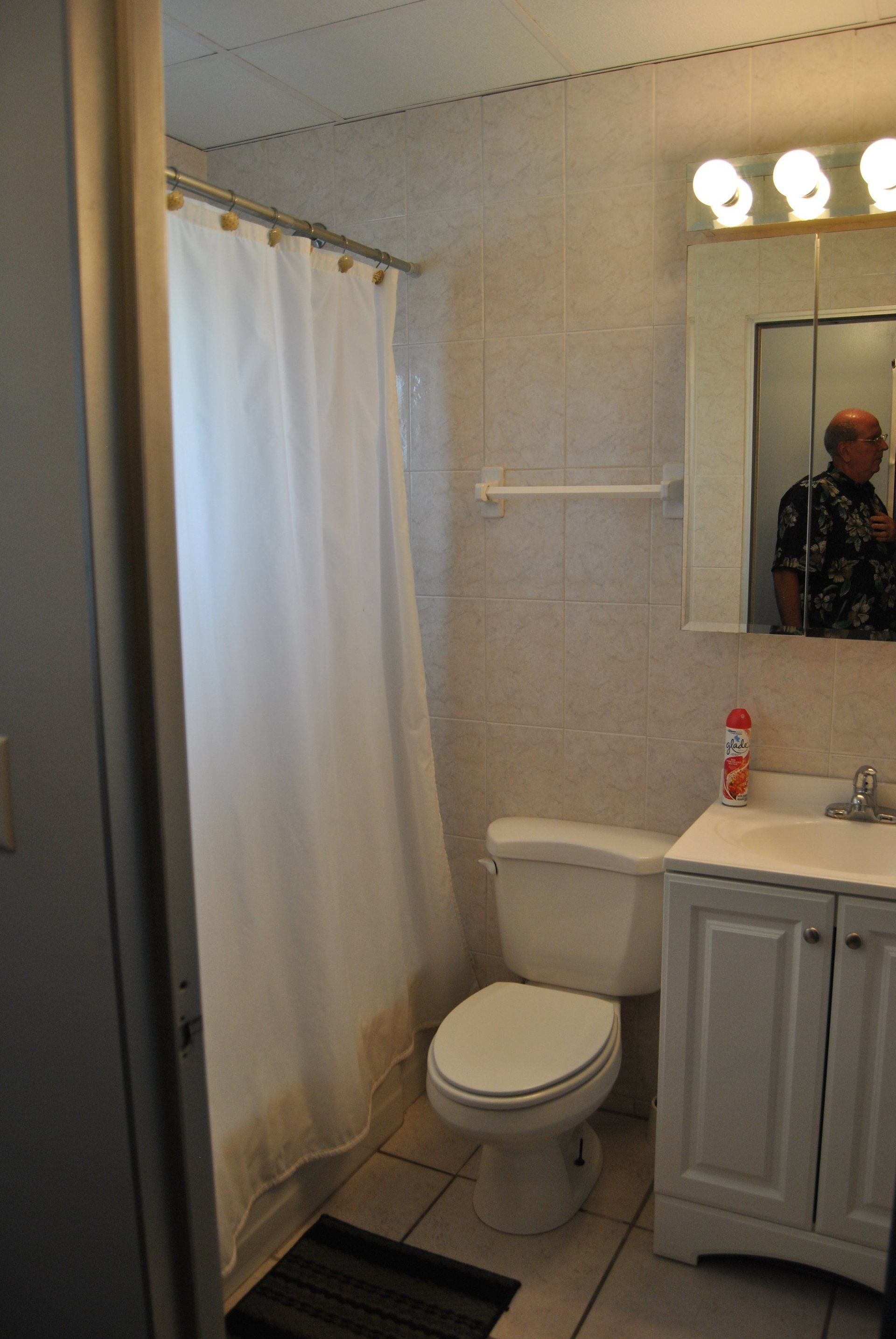 Bathroom with sink, toilet, tub and shower curtain