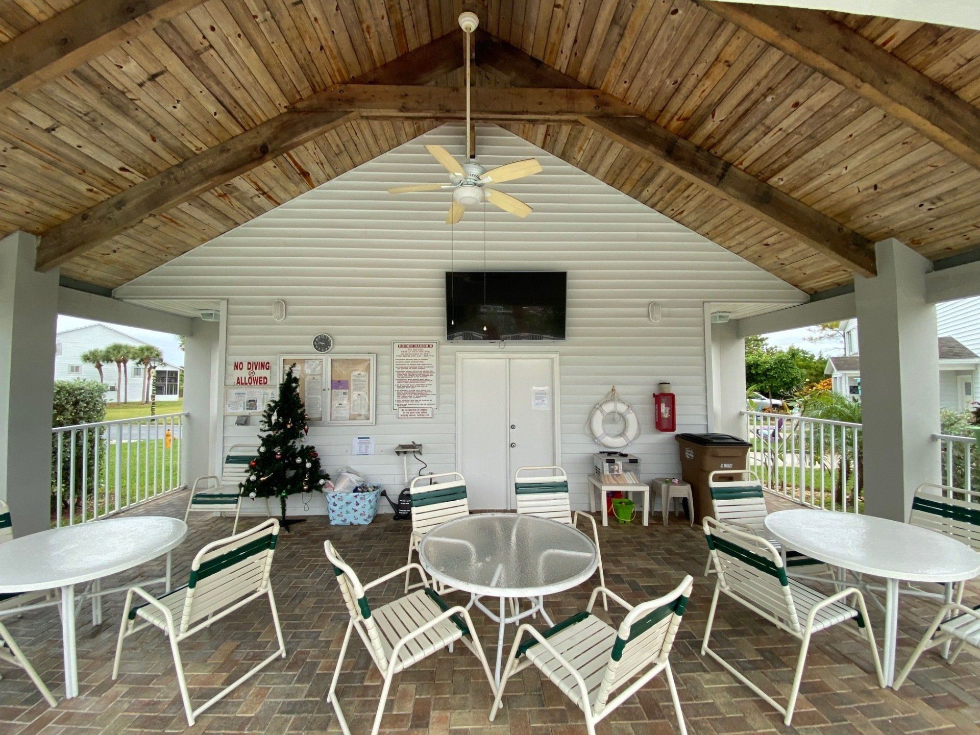 pool house with loungers and tables and chairs