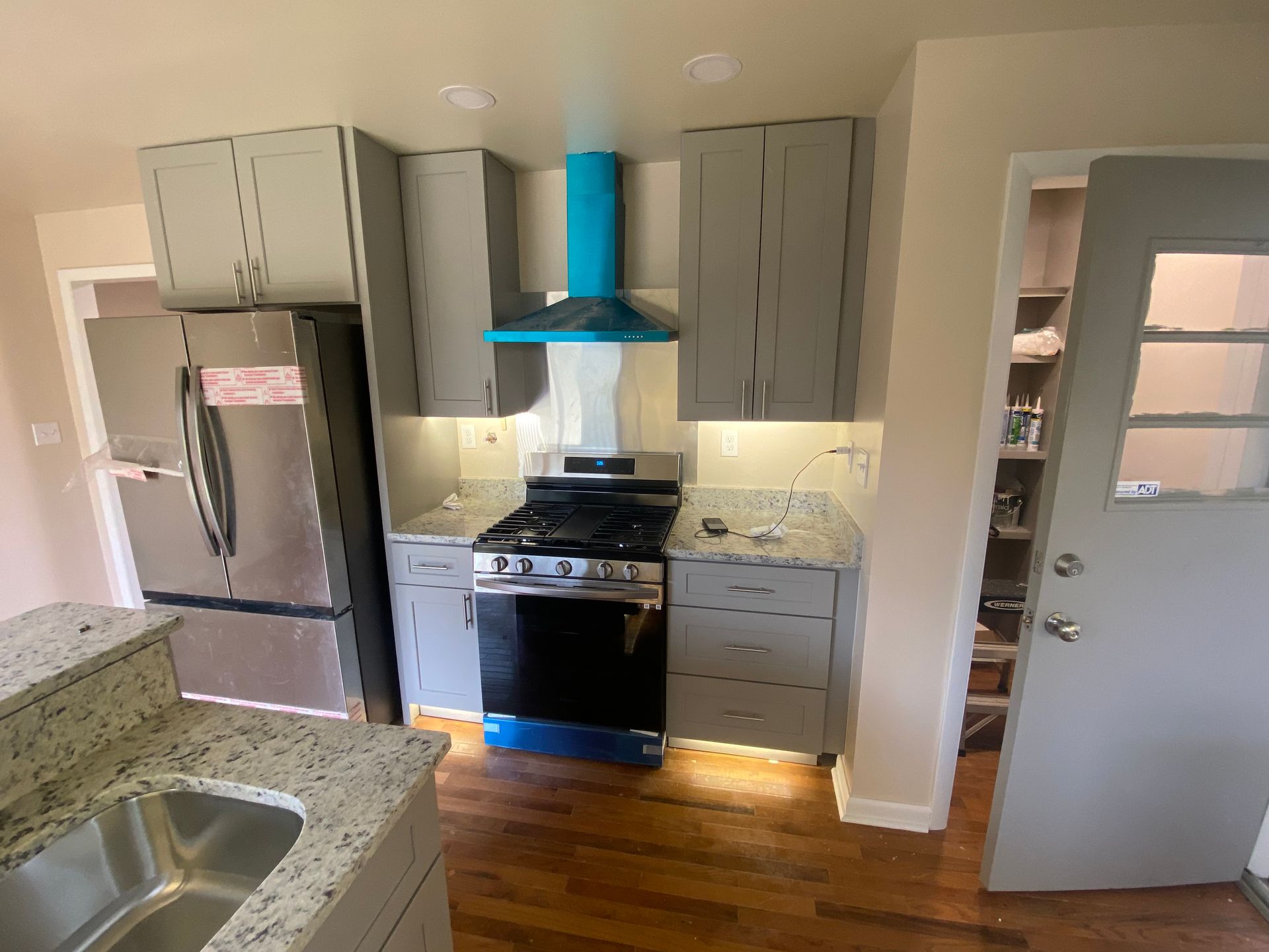 Creedmoor NC electrician running wiring for new under cabinet lights in a modern kitchen design