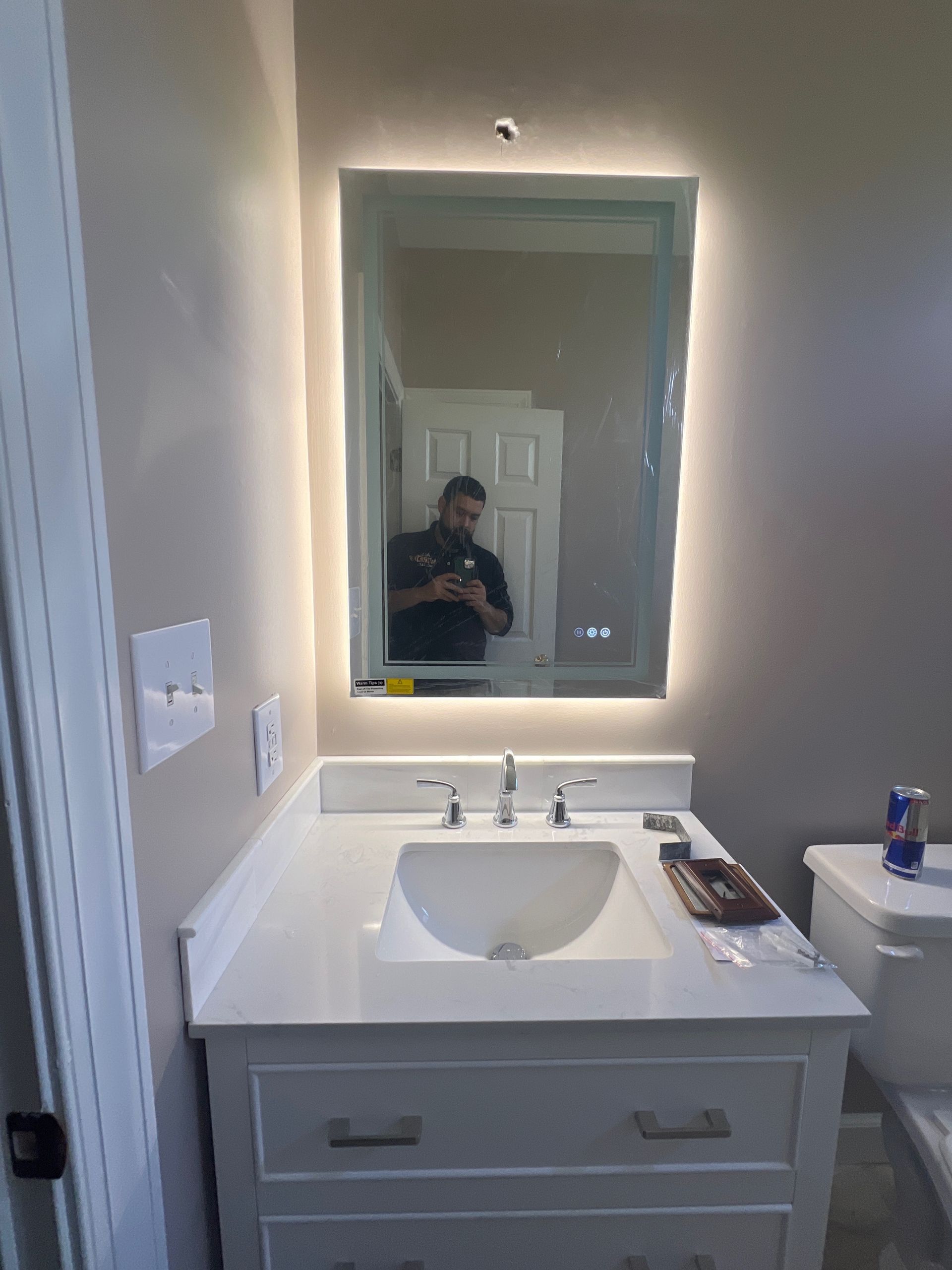 Bathroom remodel with LED backlit vanity mirror installation, GFCI outlet upgrade, and new faucet – Wake Forest, NC.