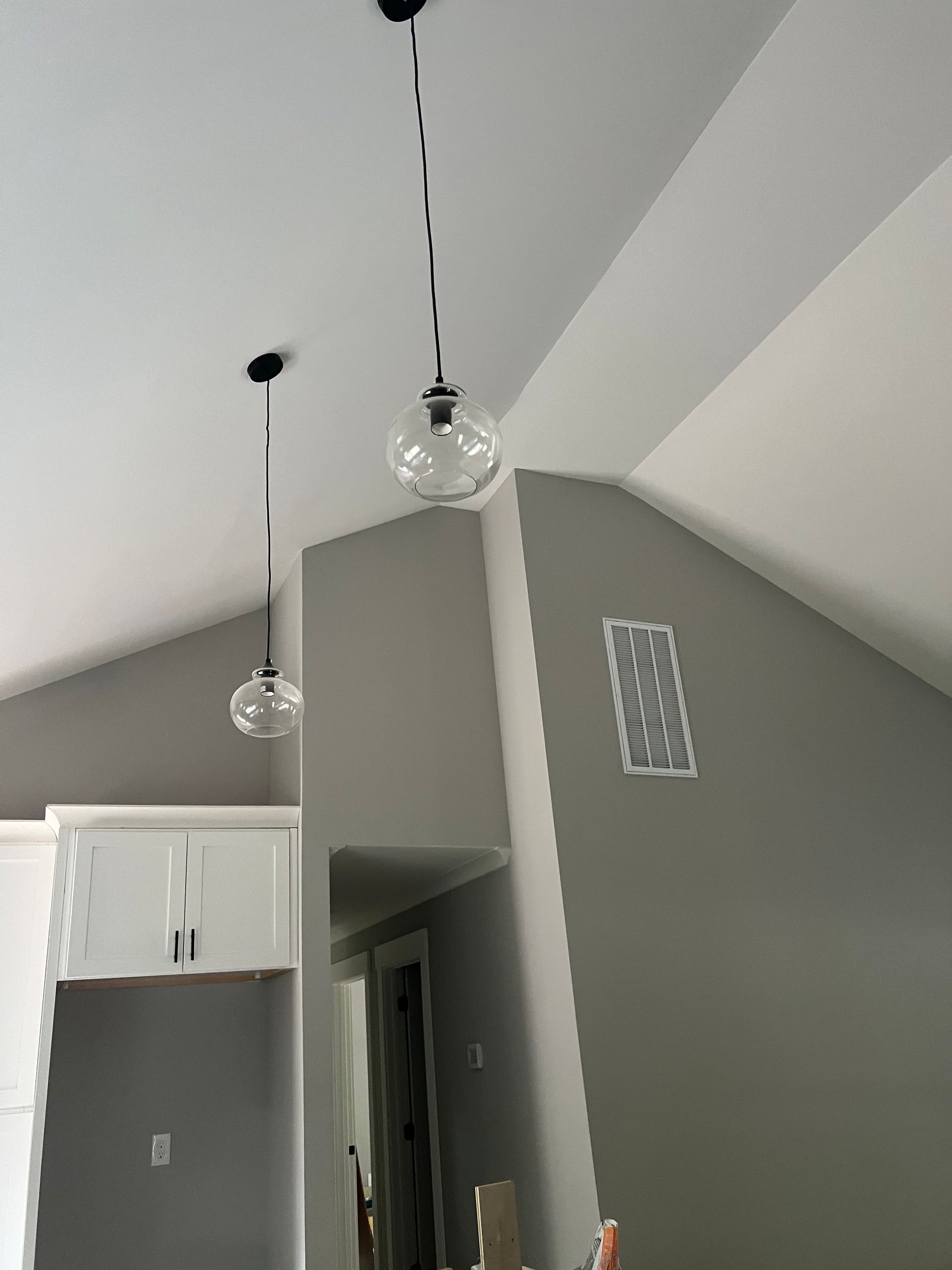 Modern kitchen lighting upgrade in Morrisville, NC, featuring pendant lights over island for improved brightness and style.