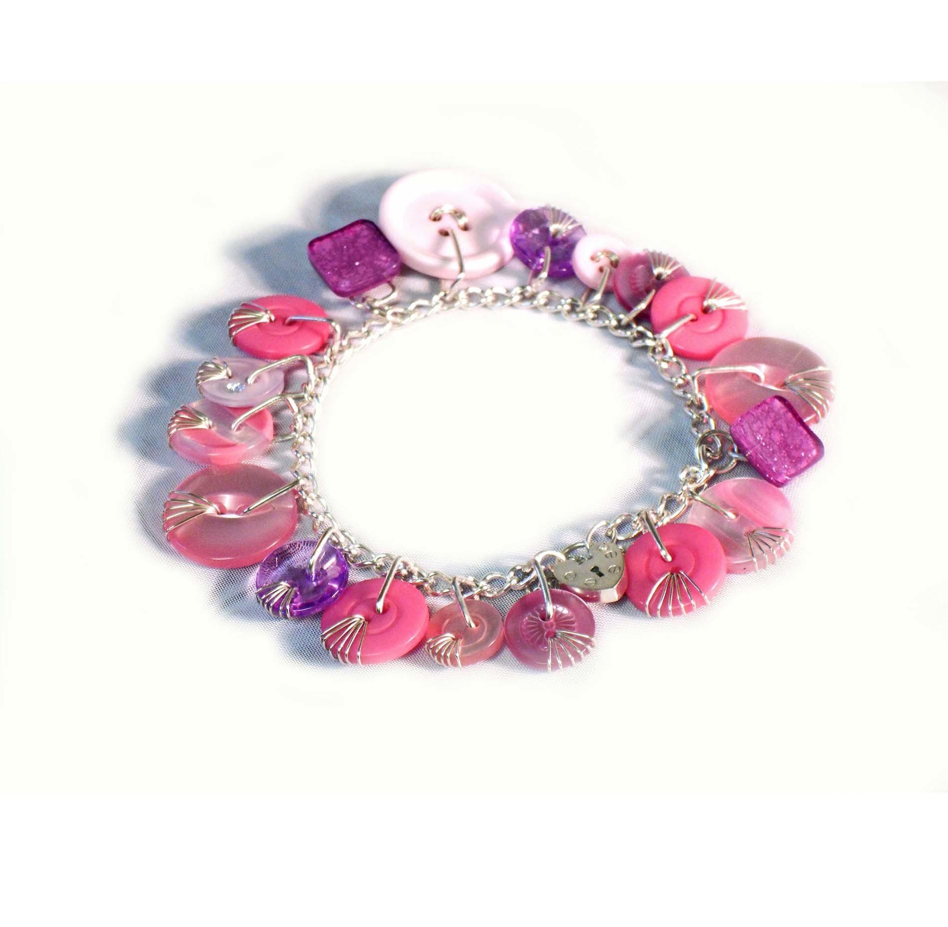 Pink button sterling silver charm bracelet with heart padlock.