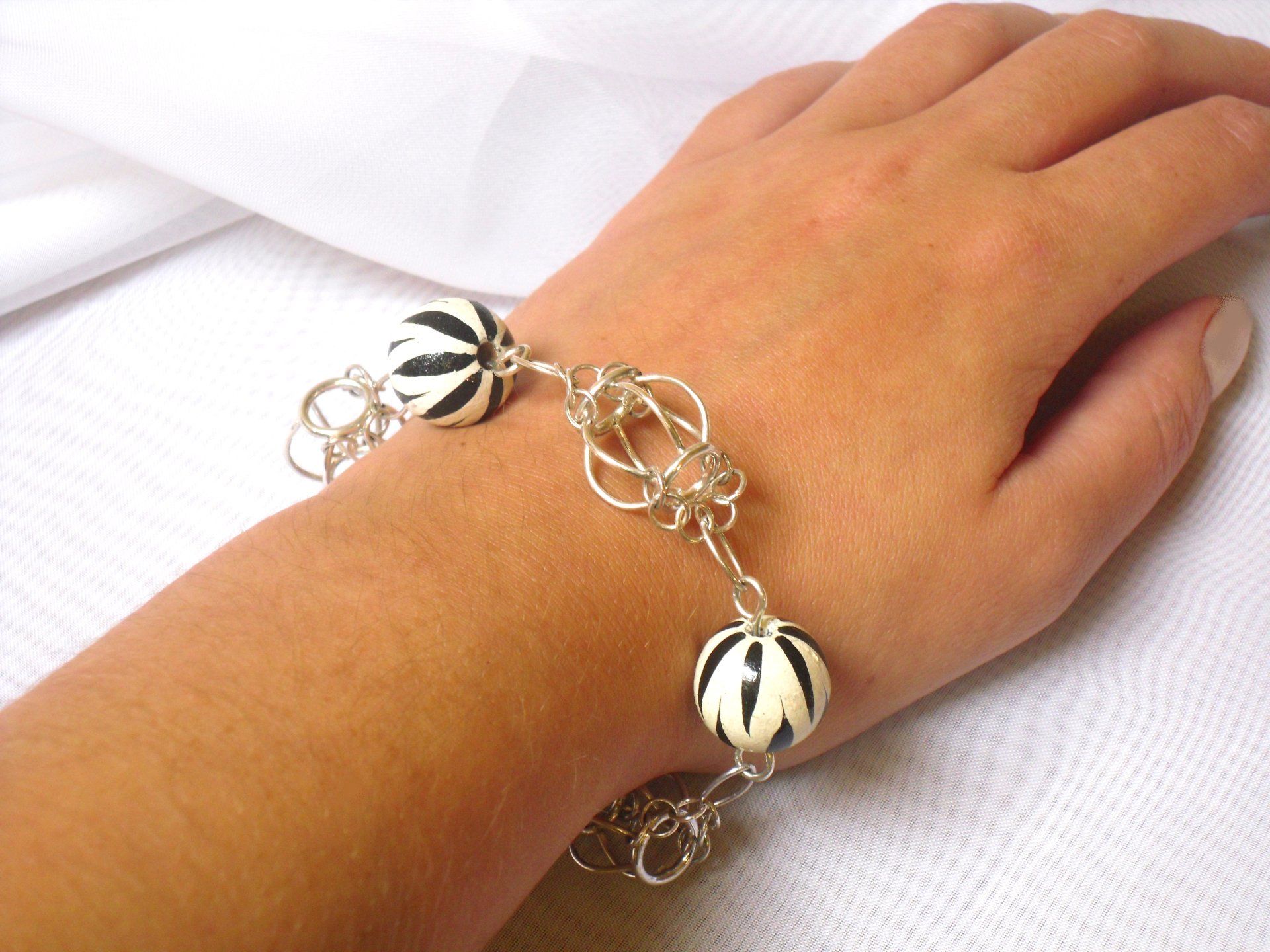 Sterling silver cage style bracelet with large black & white wooden beads.