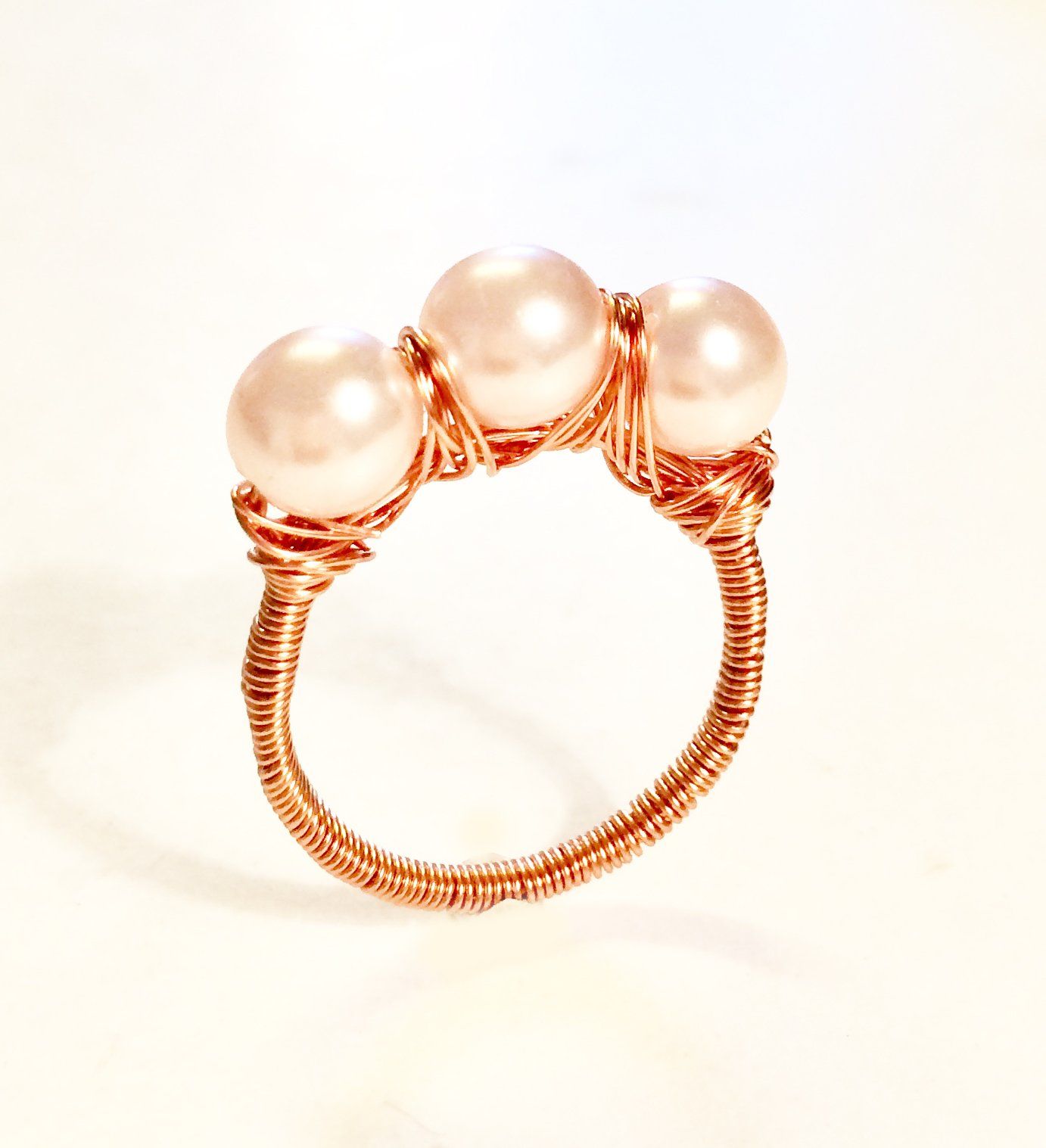 Copper, silver or gold plated wire wrapped and shaped around various types of beads to create a stunning ring.