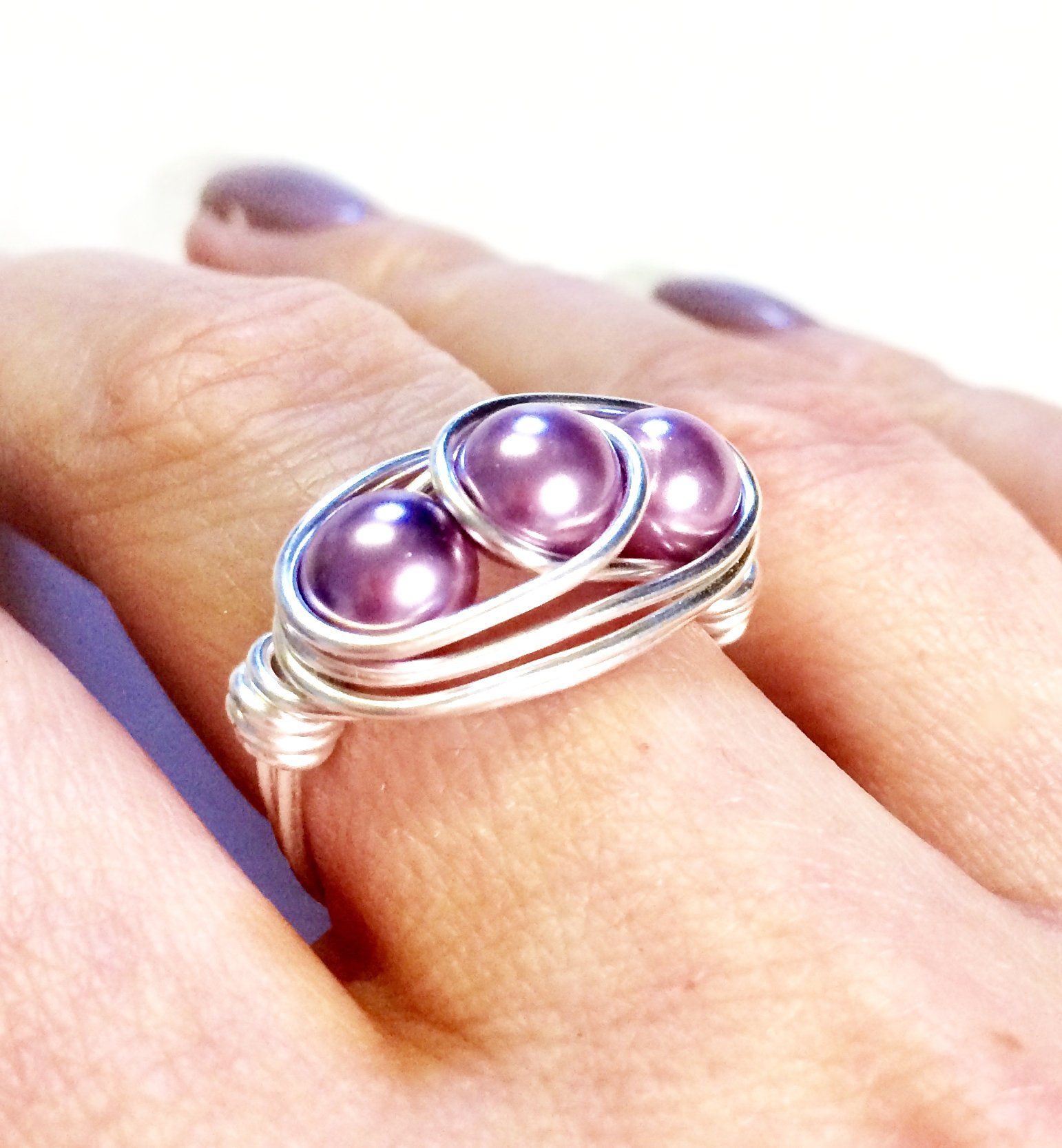 Copper, silver or gold plated wire wrapped and shaped around various types of beads to create a stunning ring.