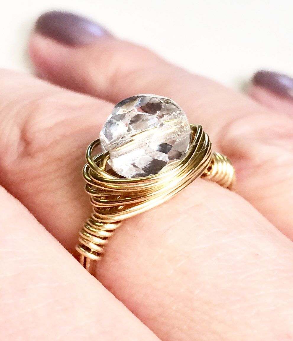 Copper, silver or gold plated wire wrapped and shaped around various types of beads to create a stunning ring.