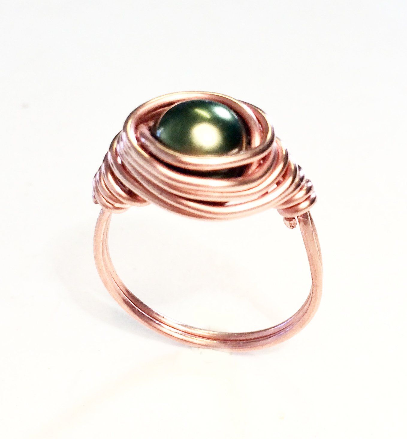 Copper, silver or gold plated wire wrapped and shaped around various types of beads to create a stunning ring.