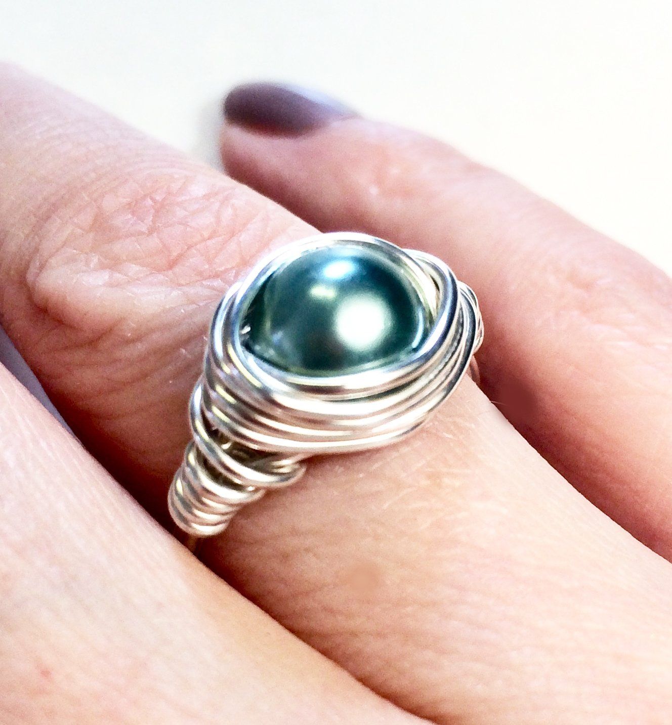 Copper, silver or gold plated wire wrapped and shaped around various types of beads to create a stunning ring.