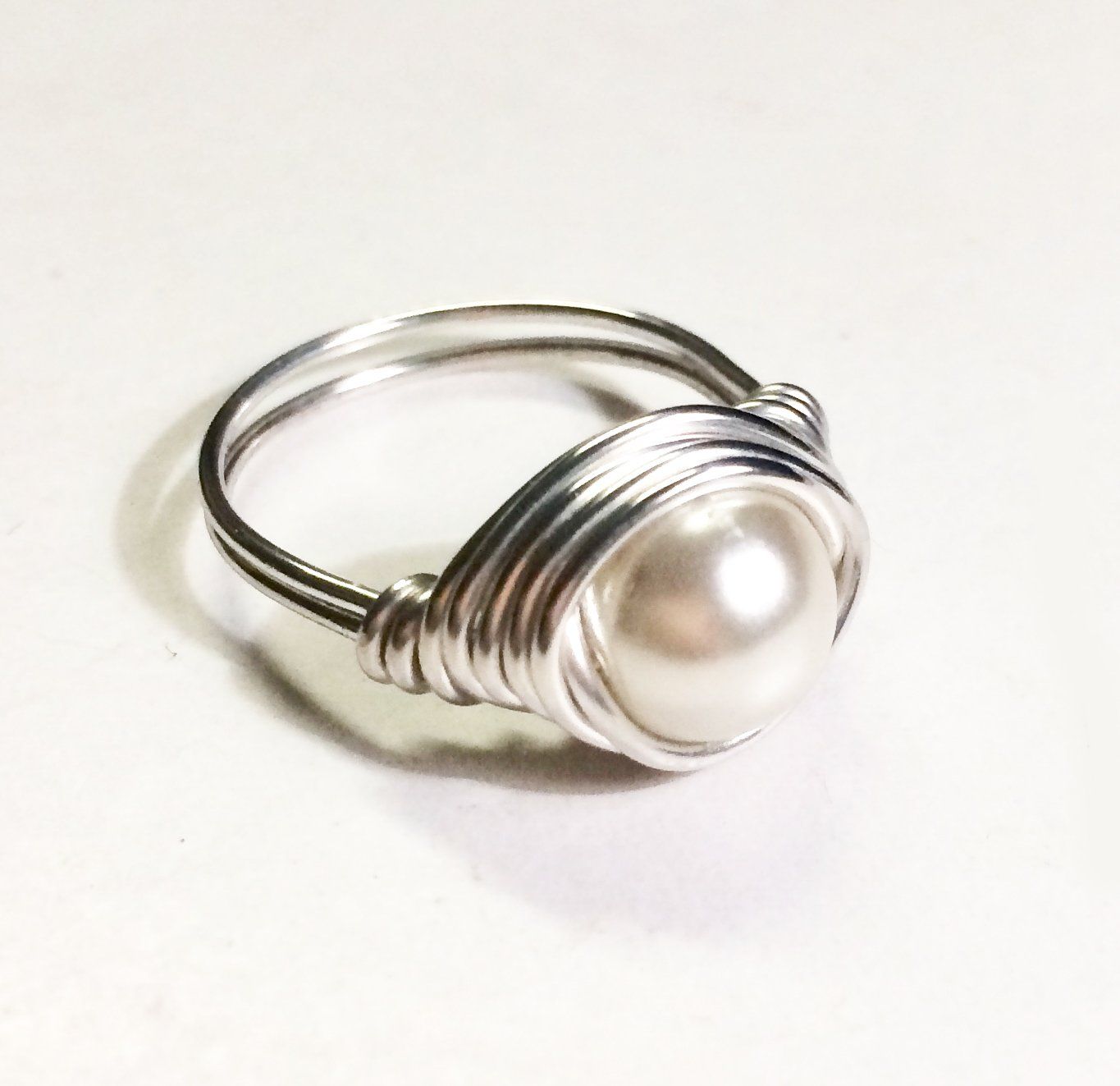 Copper, silver or gold plated wire wrapped and shaped around various types of beads to create a stunning ring.