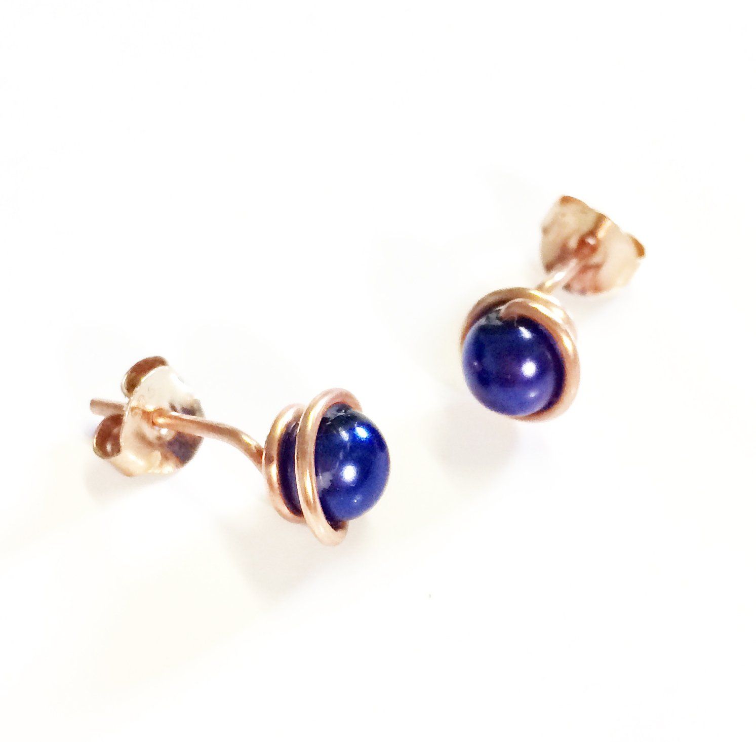 Various coloured swarovski glass pearls wrapped in plated wire to form a stud earring.