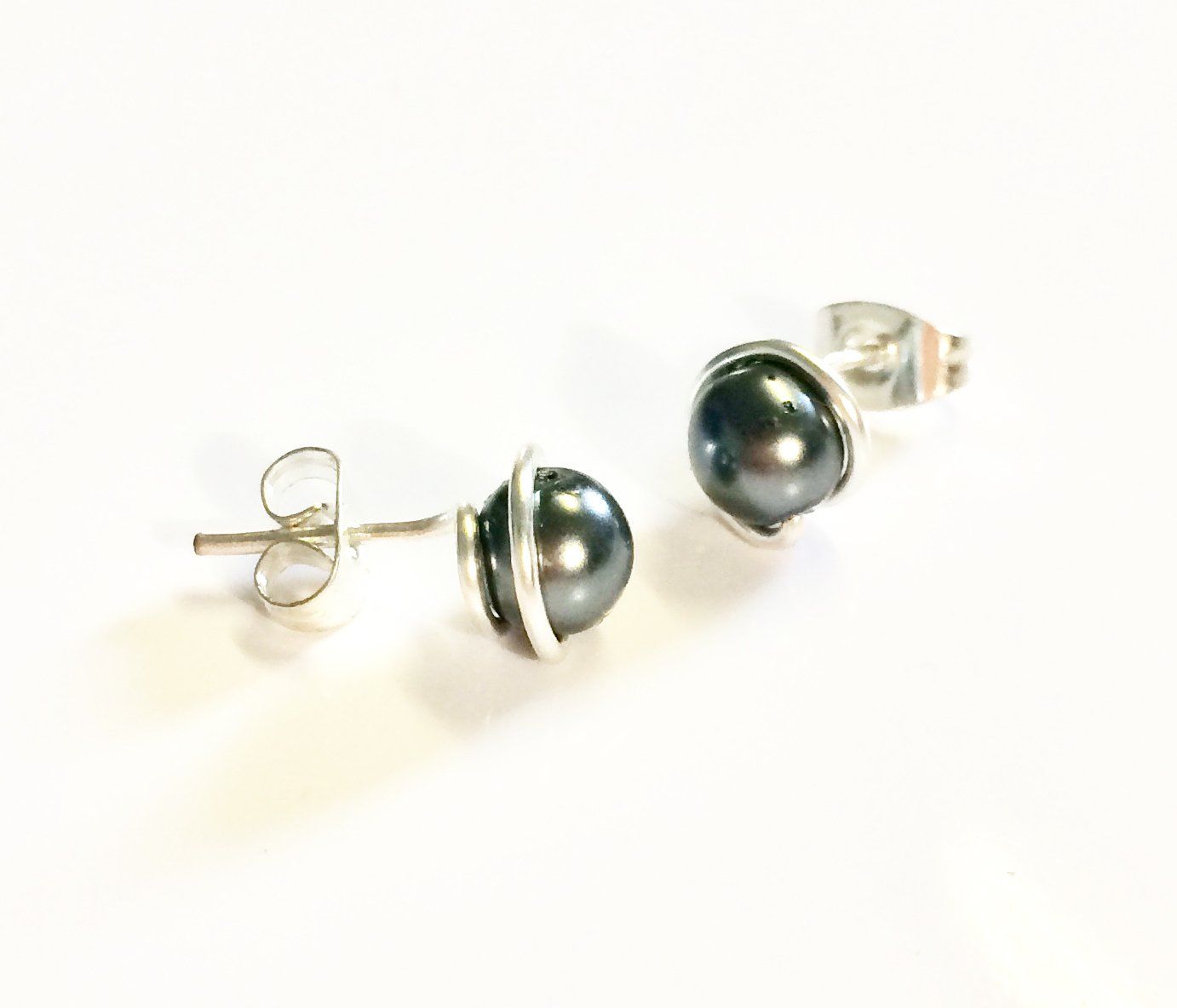 Various coloured swarovski glass pearls wrapped in plated wire to form a stud earring.
