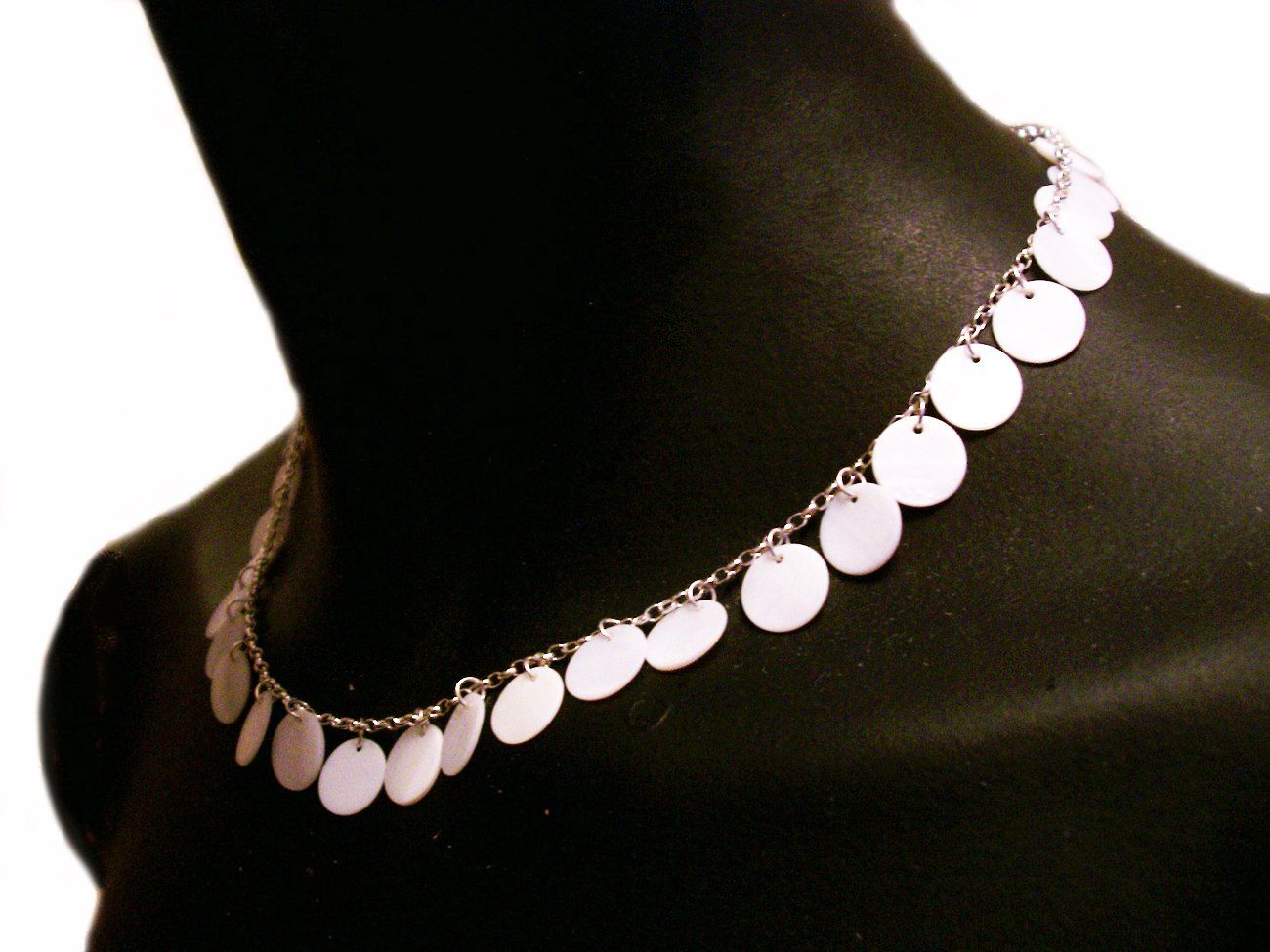 Fine sterling silver belcher chain decorated with white shell discs.