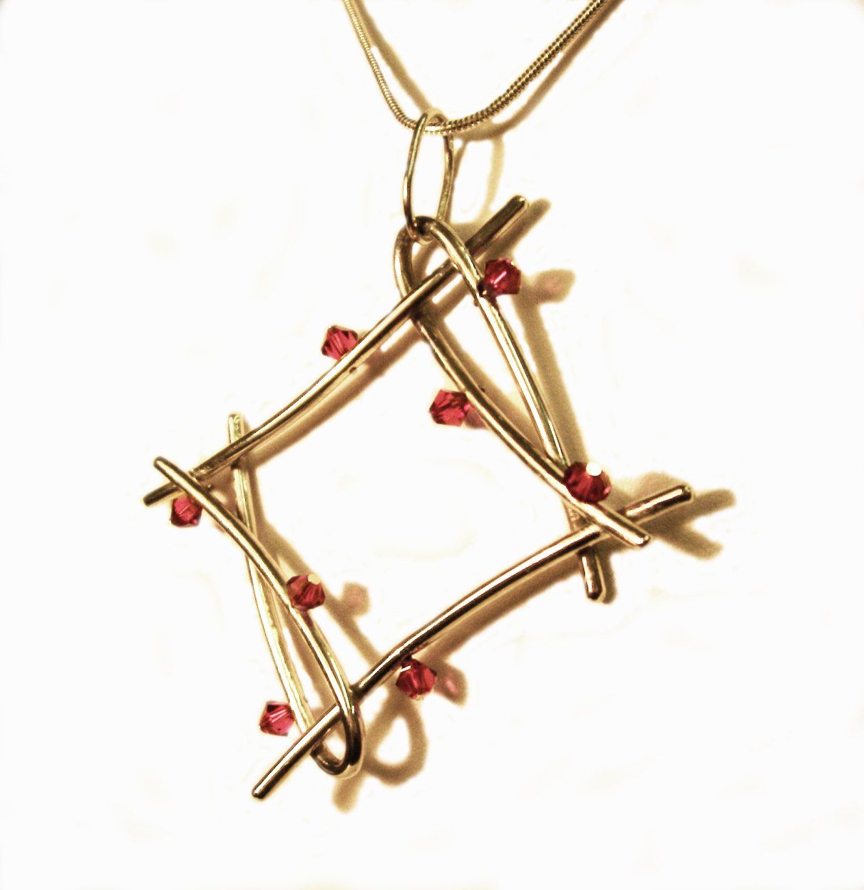 Large sculptural sterling silver pendant with pink swarovski crystal beads.