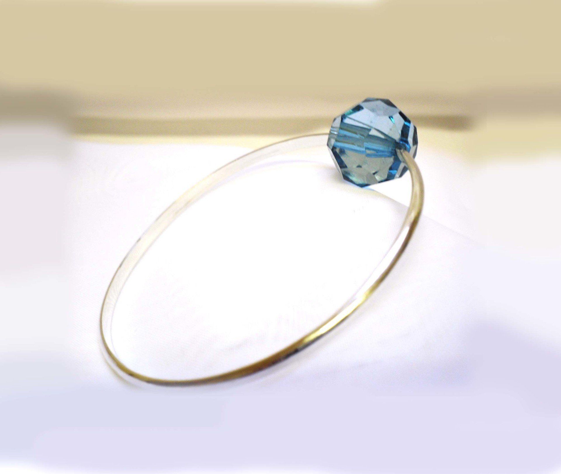 Sterling silver bangle set with a large turquoise blue faceted acrylic bead