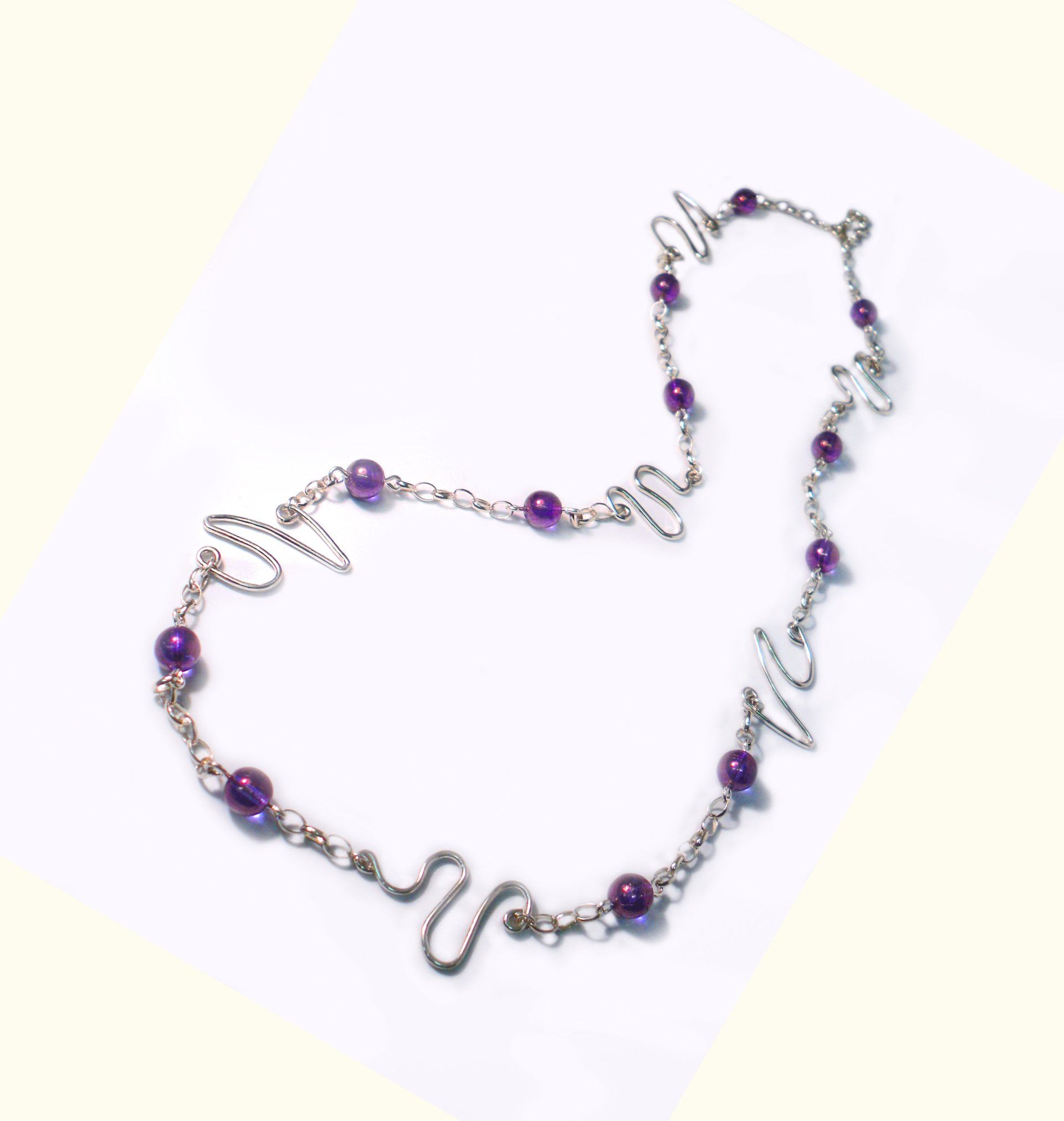 Long purple picasso beaded necklace with sterling silver wavy feature links,