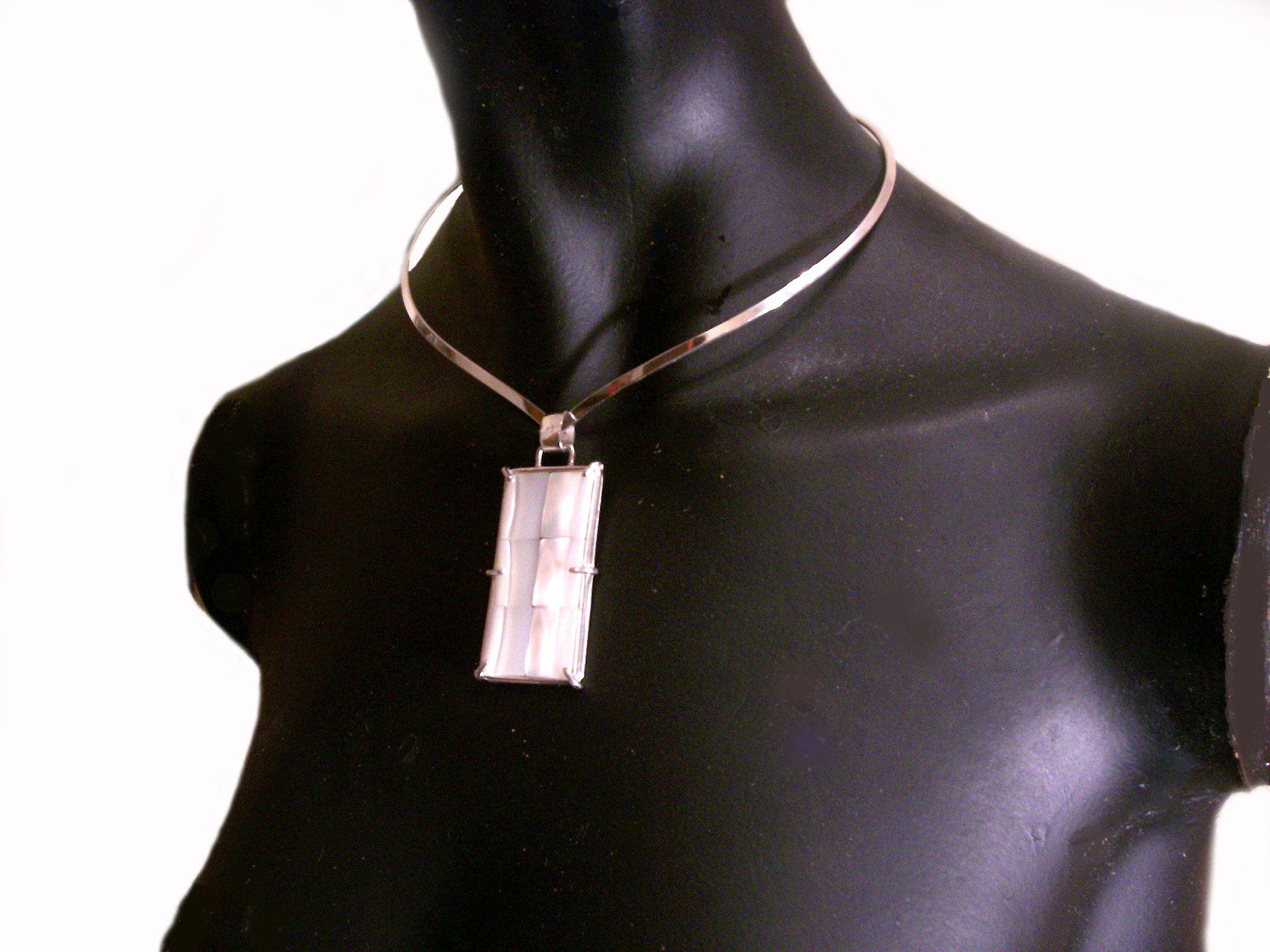Rectangular shaped sterling silver pendant set with 6 white mother of pearl tiles.