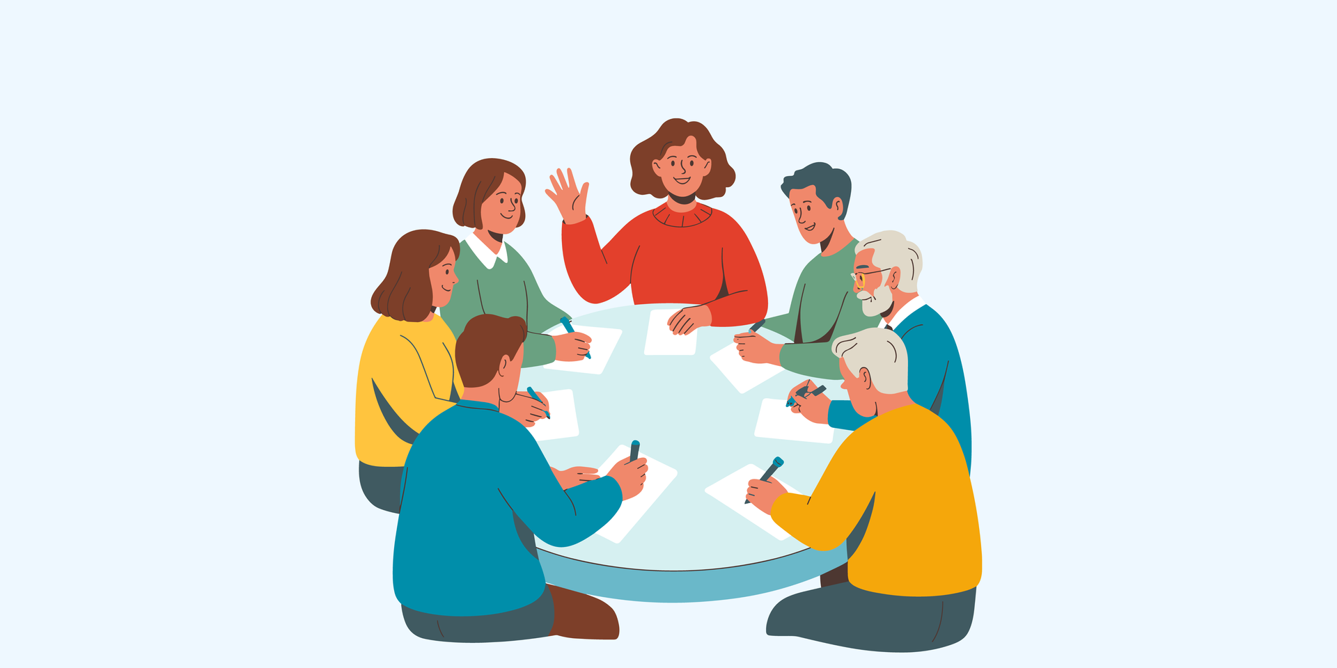 Eine Gruppe von Personen sitzen am Tisch und diskutieren gemeinsam mit Unterlagen.