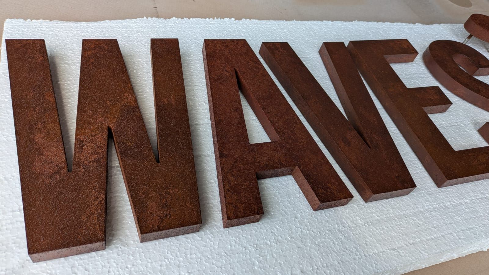 Rusty paint finish on acrylic letters by Technicolour Spraying