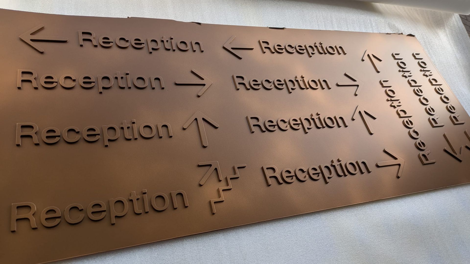 Shaded bronze metallic directional signs