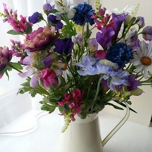 Silk Flower Arrangement with mixed cottage garden style silk flowers in a cream metal jug.