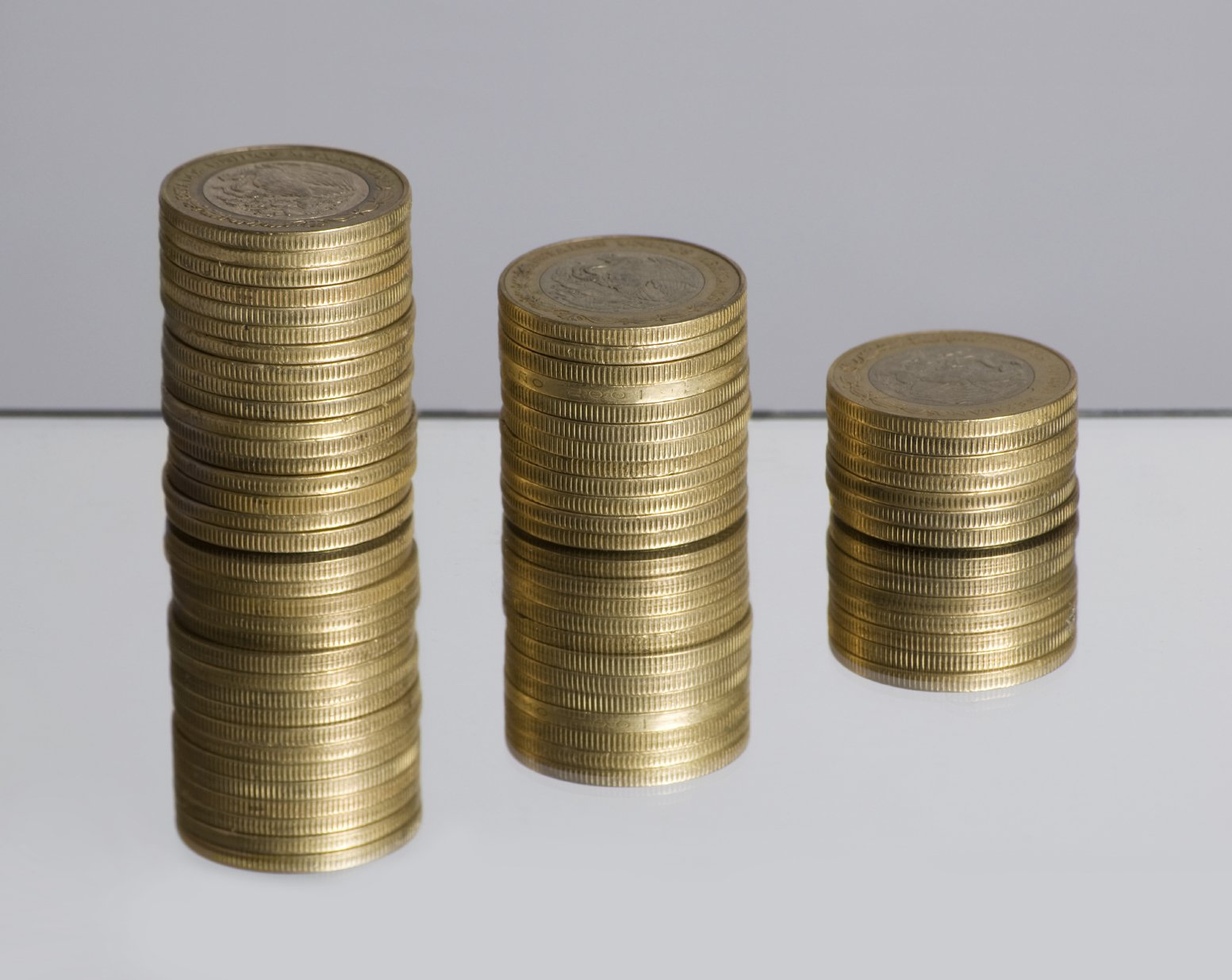 three stacks of gold coins