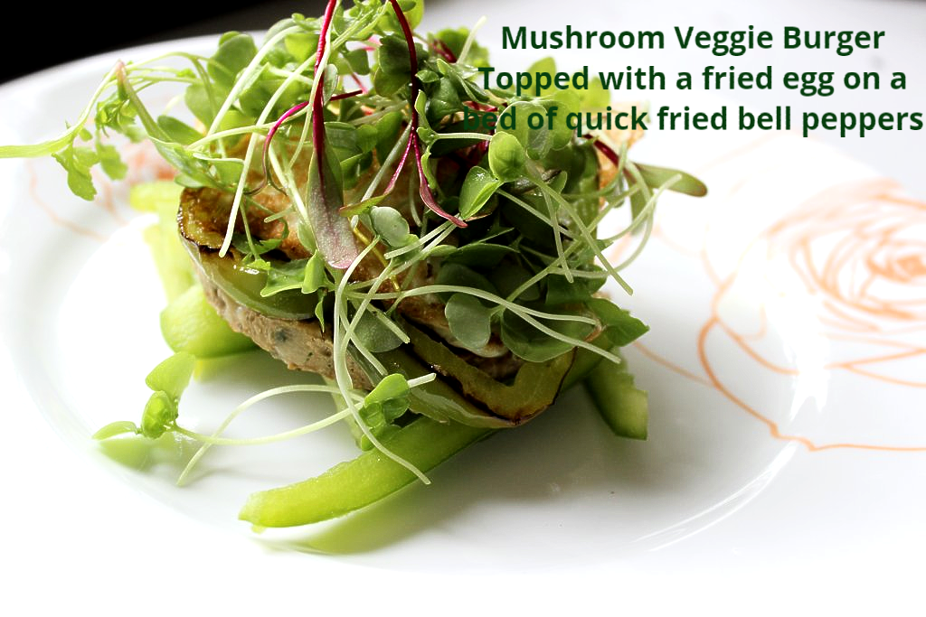 Mushroom Veggie Burger Topped with a fried egg on a bed of quick fried bell peppers