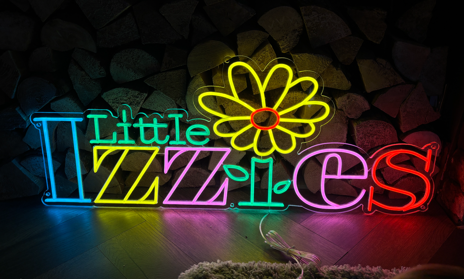 a multicoloured led neon sign of a logo