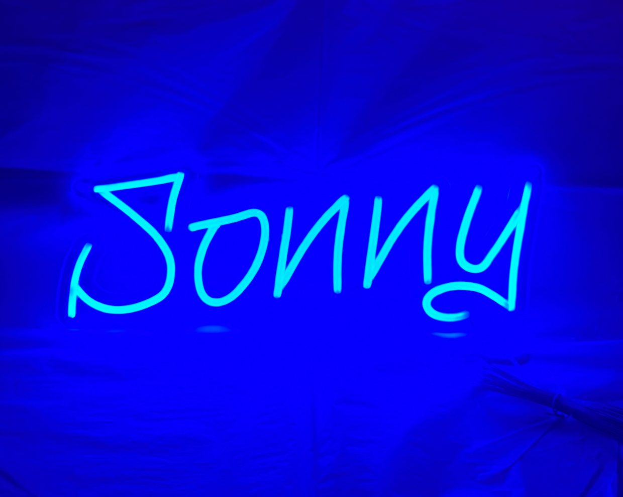 An led neon sign in blue and in the shape of the name Sonny