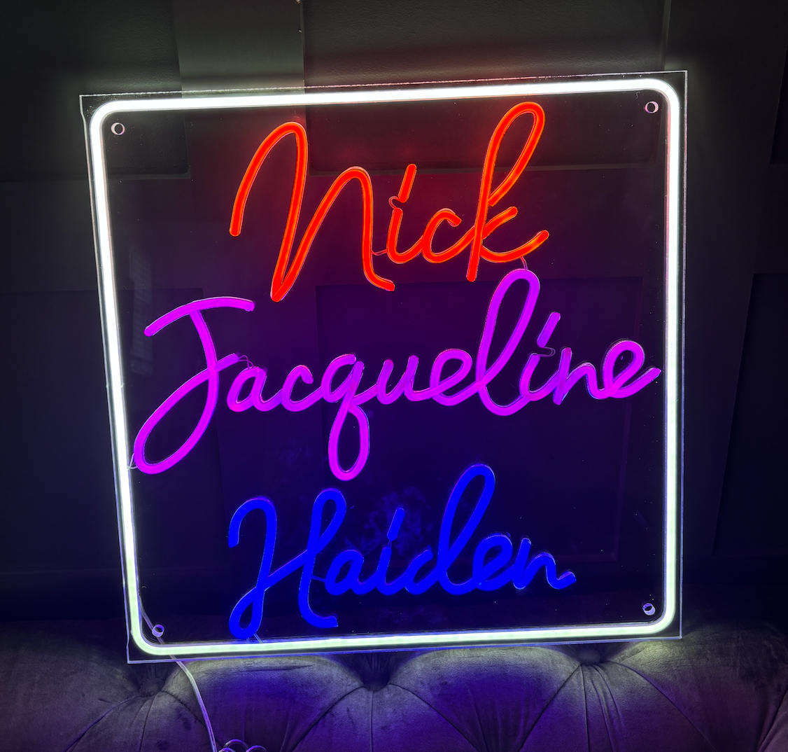 a square led neon sign with 3 names on it