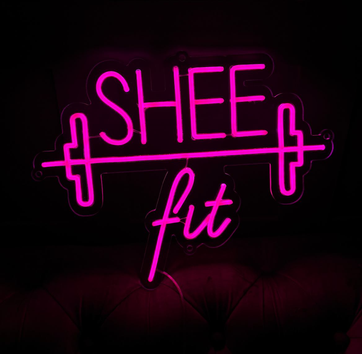 a hot pink led neon sign with a weight image to be used in a gym
